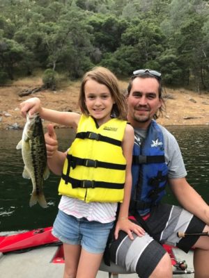 Beautiful evening on the lake for a father and his daughter