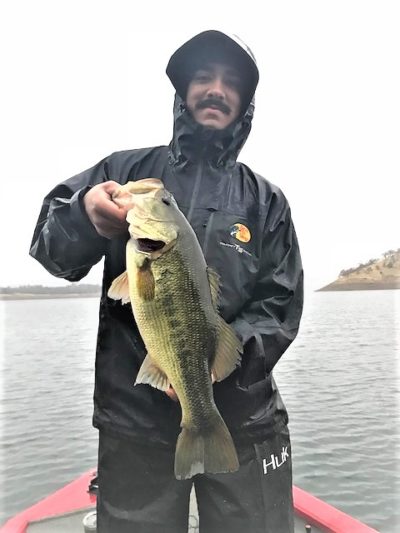 Rainy days are good for catching big bass. Getting bites helps keep you warm and dry.