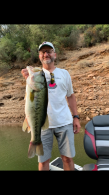 Angler hold the largest bass he has ever caught