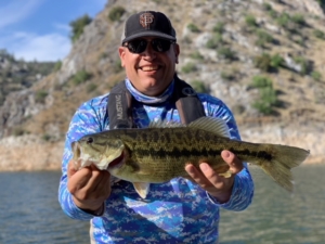 Angler hold beautiful bass in one of the most beautiful places on earth